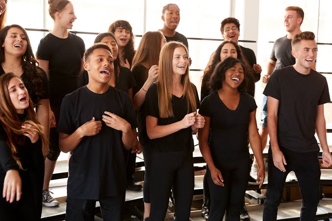 A group of young people singing together