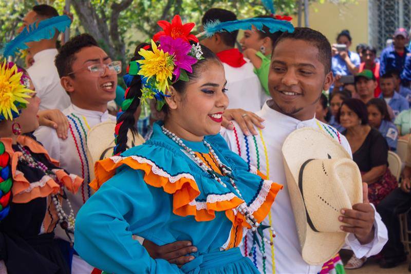 Young dancers in colorful traditional costumes smiling together